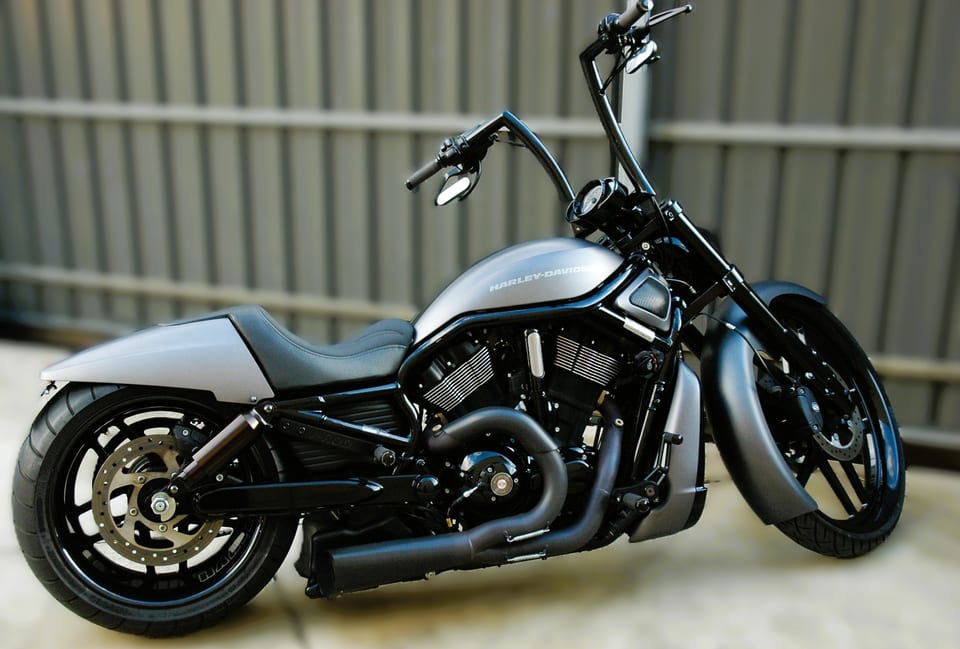 Grey Harley-Davidson V-Rod with tall handlebars and black exhaust, side view