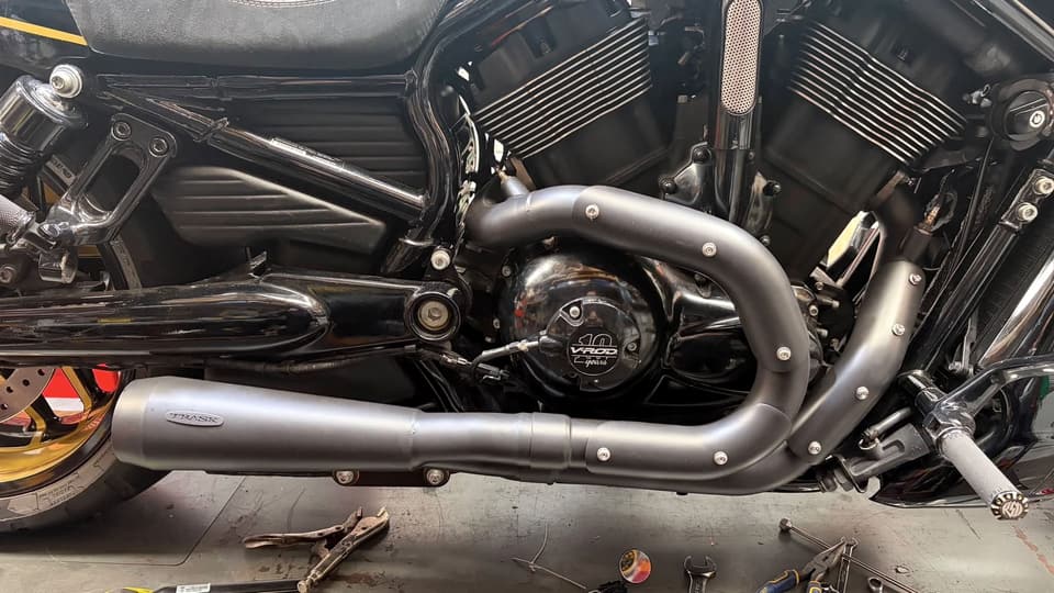 Close-up of a V-Rod engine and exhaust on the workshop lift