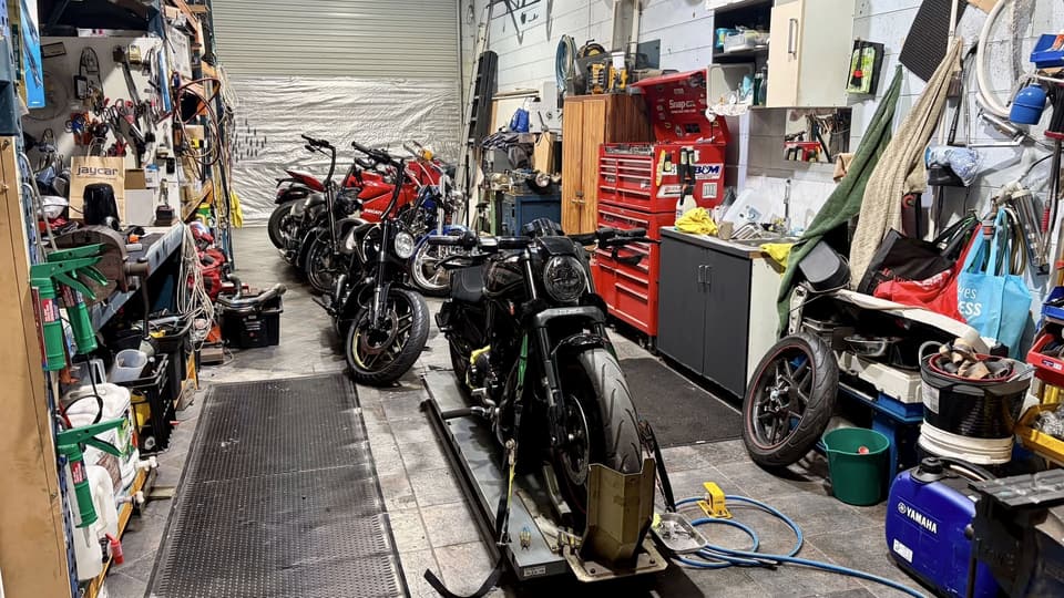 The Westside Cycles workshop: motorcycles lined up along one wall, tool chests and a bike on the lift